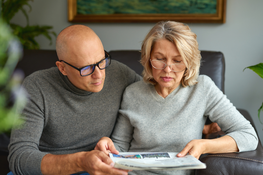 Couple reading medicare instructions